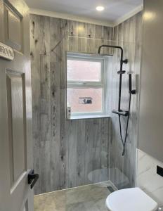 a bathroom with a shower and a toilet and a sink at The Nook House in Liverpool