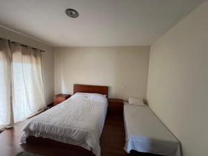 Llit o llits en una habitació de Casa Rosa Aluguel de Quartos