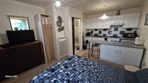 a kitchen with a counter top and a kitchen with a counter top at LE STUDIO REMCAM in Saint-Mitre-les-Remparts