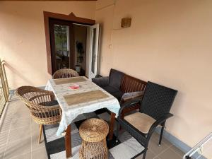 a table and chairs sitting on a balcony with a table and chairsktop at RELAX13 Vendégház in Hévíz
