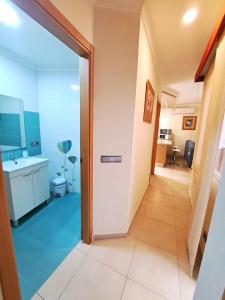 a hallway with a door leading to a bathroom at Apartamento Lola 1 in Nerja +34 photos