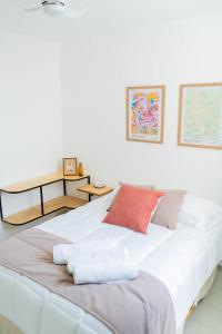 ein großes weißes Bett mit Kissen darüber in der Unterkunft Apartamento Atardecer en Aguascalientes in Aguascalientes