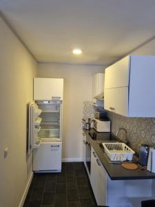 a kitchen with white cabinets and a white refrigerator at Ferienwohnung/Apartment Siegen in Siegen