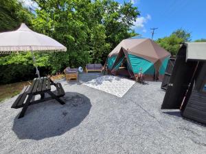a tent and a chair and a bench and a tent at Luxury Glamping in the Stargazer Dome - Beautiful Private Setting close to Narberth in Narberth