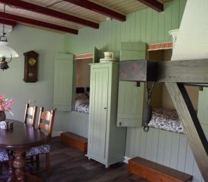 a room with a table and a bunk bed at It Foarhús in Eernewoude