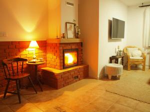 a living room with a brick fireplace and a table at Zielone Okiennice Łagów in Łagów