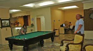a man and a woman standing around a pool table at meryemana hotel in Didim