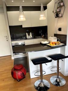 a kitchen with two bar stools and a counter top at VaticanoDreamSuite in Rome