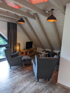 a living room with couches chairs and a tv at Ferienwohnung Mühl - einfach wohlfühlen in Marienberg