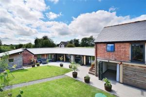 an exterior view of a house with a yard at The Cart House - Rural Retreat in Hereford