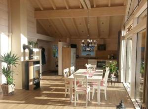 a dining room and kitchen with a table and chairs at Blockhaus Edelweiss in Rieden