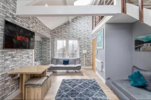 a living room with a brick wall at Central Apartment Darlington in Darlington