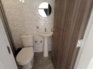 a small bathroom with a toilet and a sink at HOSPEDAJE SiLOM in Bogotá +12 photos