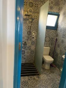 a bathroom with a toilet and a staircase to a shower at Cozy Chalet in Makadi Heights in Hurghada
