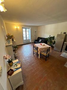 a living room with a table and a refrigerator at Casa Garibaldi in Pontremoli