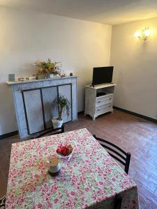 a dining room with a table and a television at Casa Garibaldi in Pontremoli