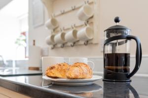 a plate of bread on a counter next to a coffee maker at Brook Farm Barn in Frodsham