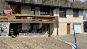 a house with a porch and a patio at Zimmer in den Voralpen in Grub