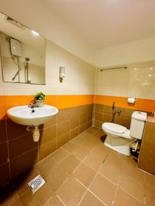 a bathroom with a toilet and a sink at Swing & Pillows - Kajang Selangor in Kajang