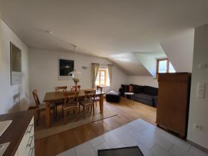 a kitchen and living room with a table and chairs at Großschlipfhof in Silandro