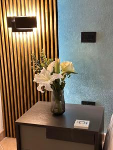 a vase of flowers on a table in a room at La balena bianca house in Bagni San Filippo