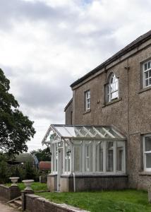 an old brick house with a conservatory at Mountrothe House in Kilkenny