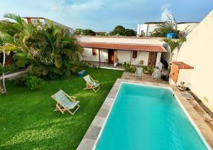 an aerial view of a house with a swimming pool at Pousada Casa Do Cocotier in São Miguel do Gostoso