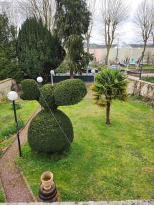 a bush shaped like a rabbit sitting in the grass at Maison FOCH in Évreux