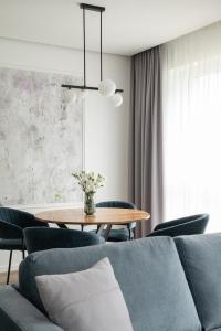 a dining room with a table and chairs at No. 1 PARK AVENUE APARTMENT in Kaunas