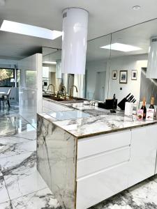 a kitchen with marble counter tops and a large mirror at Luxury Redcar Seaside Retreat in Redcar