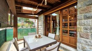 a dining room with a white table and chairs at Casa Las Xanas in Llanes
