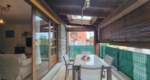a dining room with a table and chairs on a balcony at Casa Las Xanas in Llanes