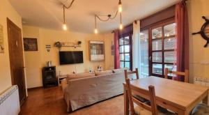 a living room with a couch and a table at Casa Las Xanas in Llanes