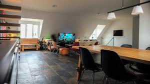 a living room with a large wooden table and chairs at Luxury Penthouse in the heart of the City in Copenhagen