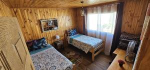 a small room with a bed and a window at Hostal Sol y Luna in Santiago