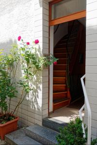 a staircase leading to a house with pink flowers at B10-LINDE in Baden-Baden