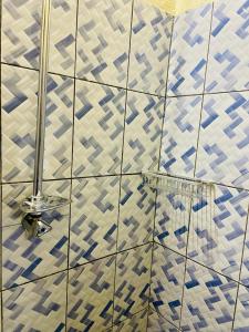 a bathroom with a blue and white tiled wall at Seïf Industry's in Ouagadougou
