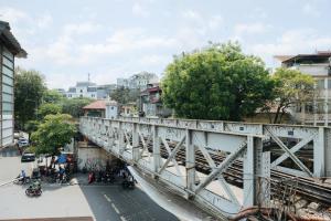 a bridge over a street in a city at Unique Train street / Old Quarter View Apartment in Hanoi