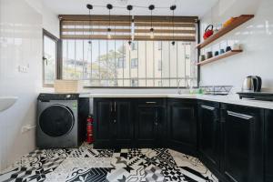 a kitchen with a washer and dryer on a floor at Unique Train street / Old Quarter View Apartment in Hanoi