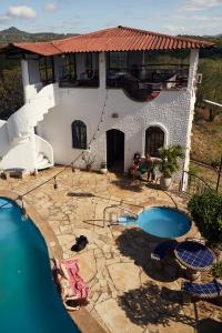 a house with a swimming pool in front of it at Beachside stay at Villa ViYarte in San Juan del Sur