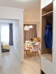 a room with a table and a dining room at Apartament Grabówek in Gdynia