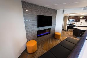 a living room with a fireplace and a tv at Downtown 1br Gem Steps Away From Wells Fargo in Des Moines
