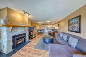 a living room with a couch and a fireplace at Marble Canyon in Fairmont Hot Springs