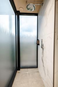 una puerta de cristal que conduce a una ducha en el baño en Ewe and Me Glamping en Northallerton