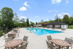 a pool with tables and chairs and a pavilion at New Lake Como Condo with Lake Views in Lake Geneva