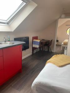 a room with a bed and a sink and a table at Shindilla Cottage Air B&B in Galway