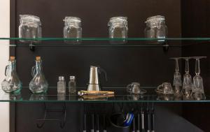 a shelf with many glass bottles on it at Home Sweet Home in Rho