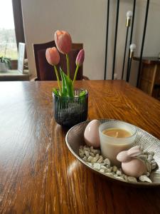 a wooden table with a plate of eggs and flowers at Freiblick 3 Bad Glbg mit Terrasse Top 3 in Bad Gleichenberg