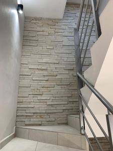 a staircase with a brick wall at New Modern Condo with Air-condition in Zapotlanejo