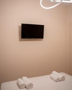 a room with two towels on a bed with a television at Kostis Luxury Apartment in Agrinion